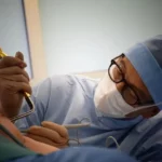 A surgeon performing breast augmentation