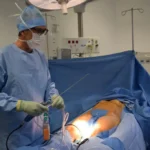 A surgeon doing liposuction