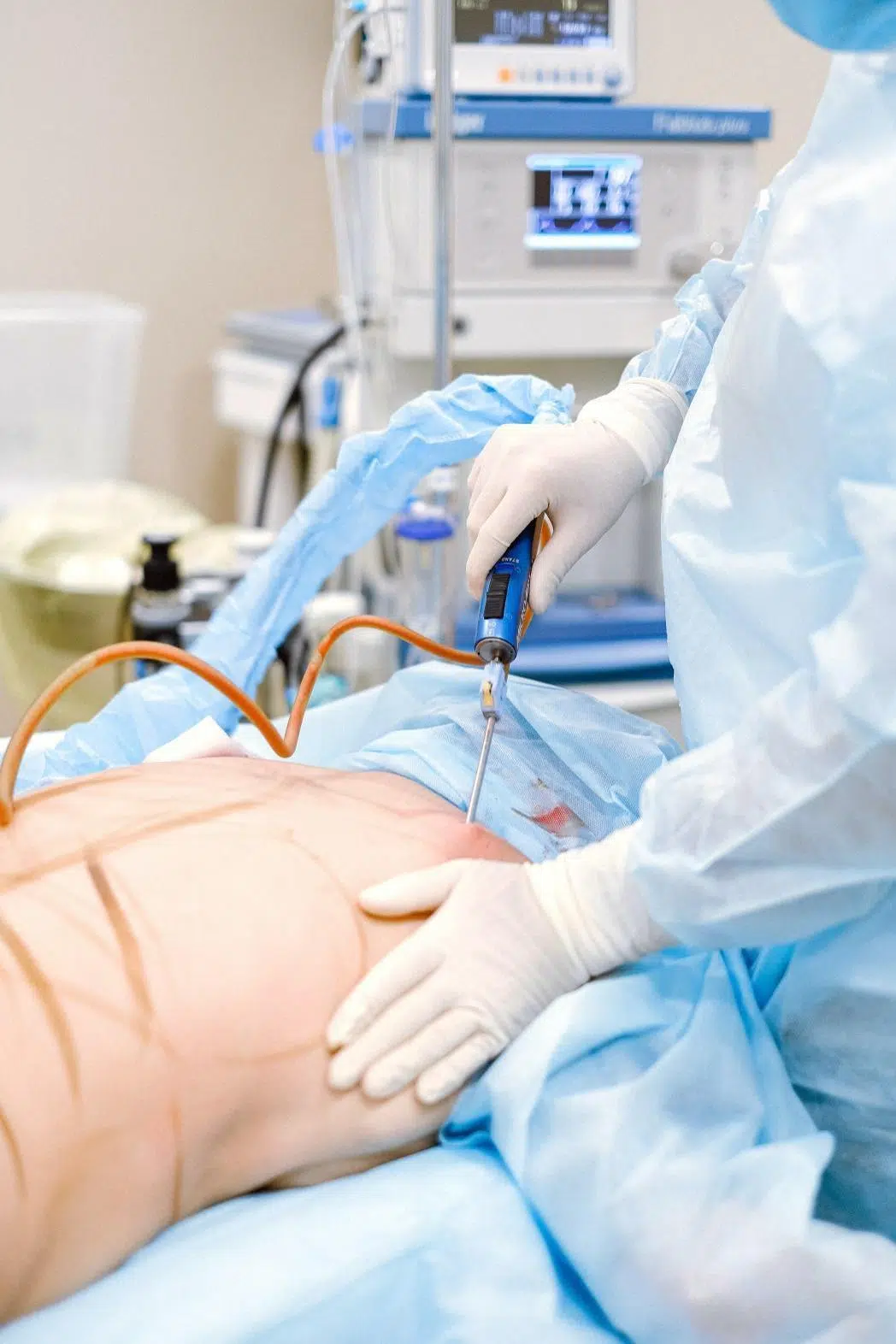 A surgeon performing liposuction