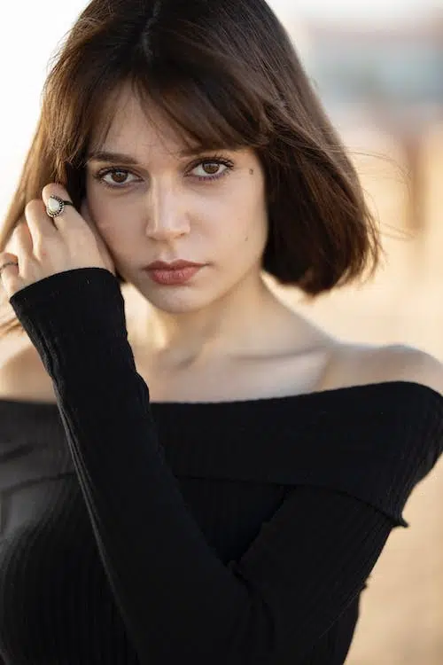 A woman wearing black off-shoulder top