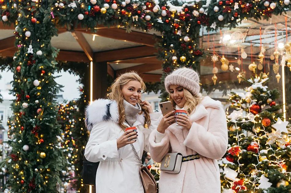 two women near christmas decorations
