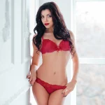 confident woman in red lingerie showcasing results after designer vagina surgery