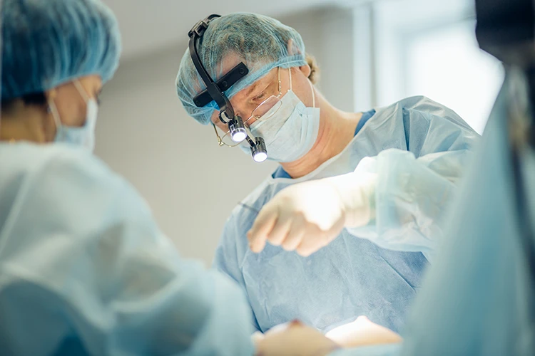 Cosmetic surgeon performing surgery in a sterile operating theatre