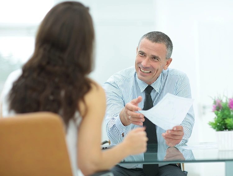 Male consultant discussing treatment options with a patient during an in-person consultation