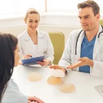 consultant plastic surgeon discussing breast implant options during a breast augmentation consultation