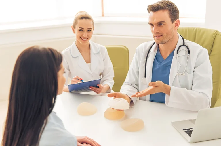 consultant plastic surgeon discussing breast implant options during a breast augmentation consultation