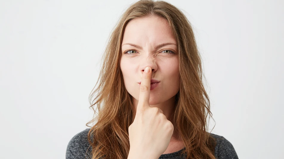Woman pointing to her nose to represent bulbous nose job and nose tip reshaping concerns